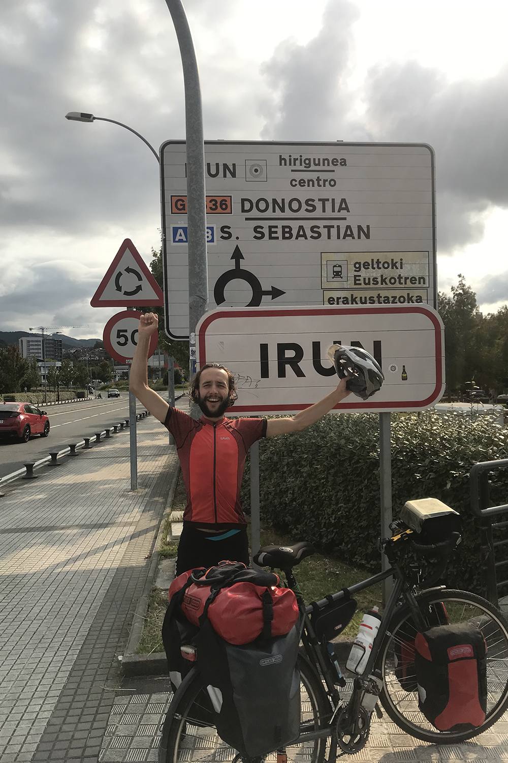 Moses Köhler stands in front of the town sign of the Spanish town of Irun.